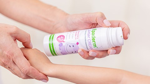 Person applying Junior Epaderm Cream to child's arm